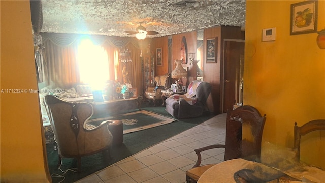 living room featuring ceiling fan and light tile patterned flooring