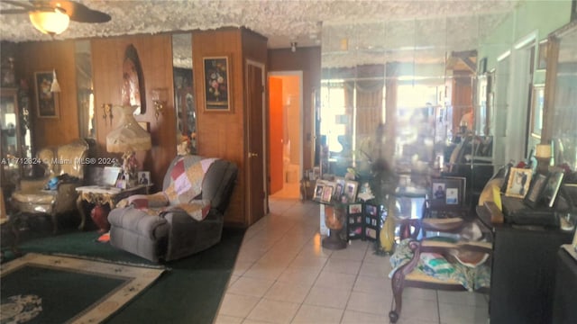 tiled living room with ceiling fan