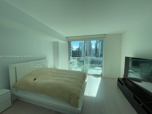 bedroom featuring hardwood / wood-style floors and access to exterior