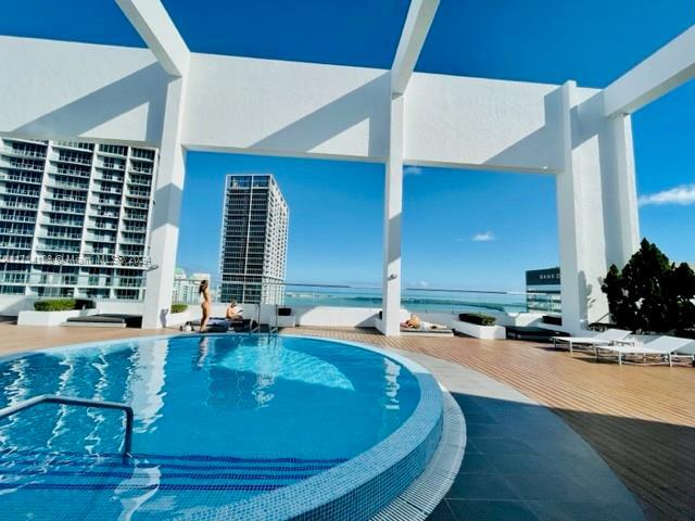 view of swimming pool with a wooden deck