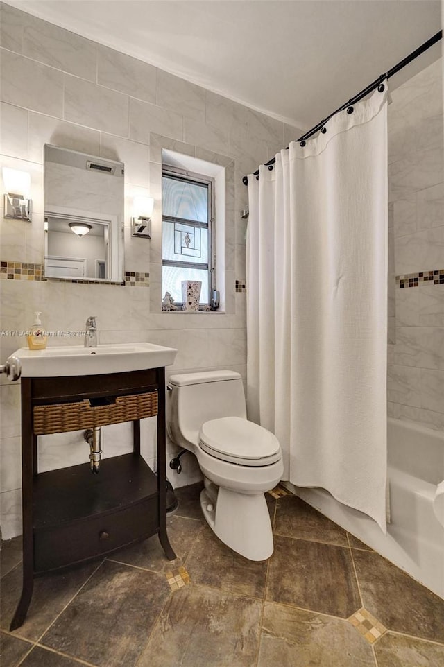 full bathroom featuring shower / bath combo, tile patterned floors, sink, tile walls, and toilet