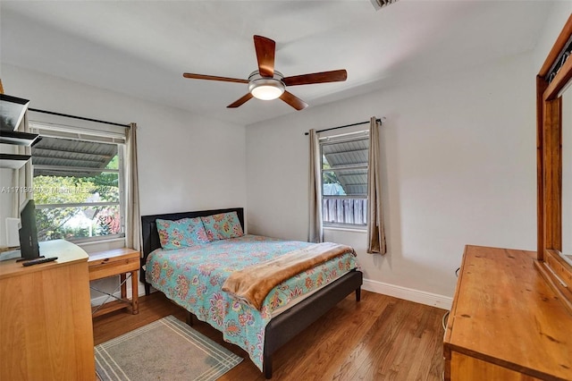 bedroom with hardwood / wood-style flooring and ceiling fan