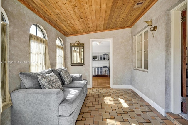 living room with ceiling fan, wood ceiling, lofted ceiling, and ornamental molding