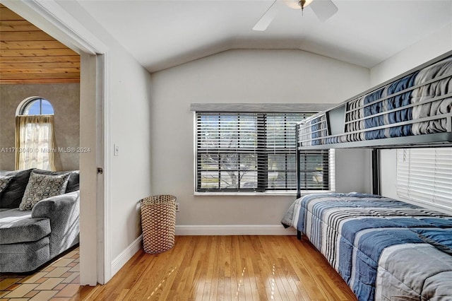 bedroom featuring hardwood / wood-style flooring, ceiling fan, and lofted ceiling