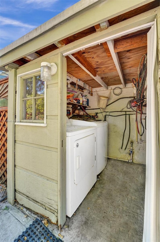 clothes washing area with washer and clothes dryer