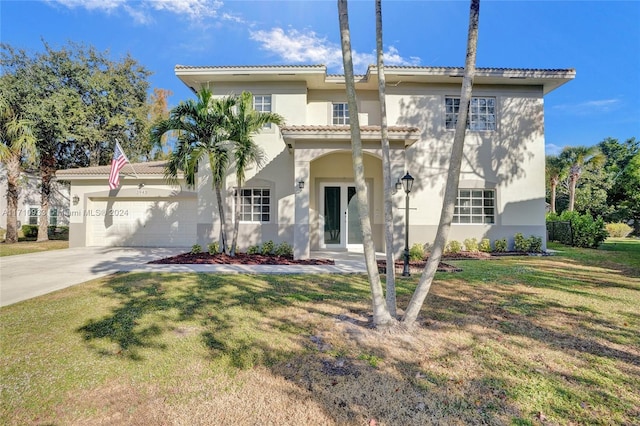 mediterranean / spanish-style home with a garage and a front yard