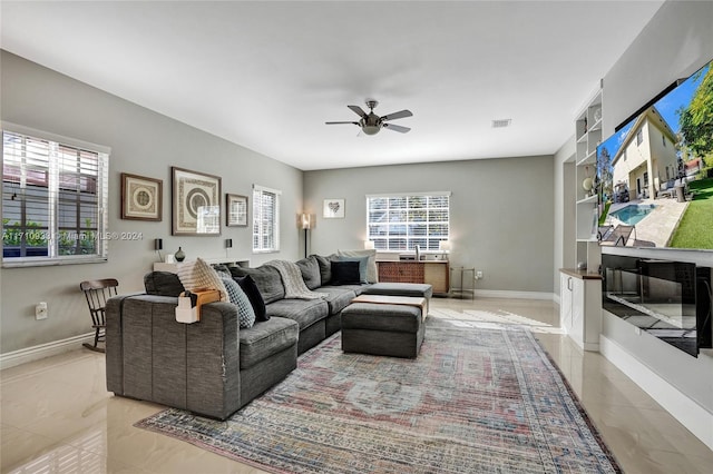 living room with ceiling fan and plenty of natural light