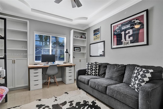 office area featuring built in shelves, ceiling fan, and a tray ceiling