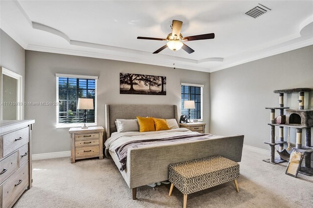 bedroom with light colored carpet, a raised ceiling, ceiling fan, and crown molding