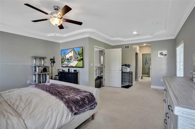 carpeted bedroom featuring a raised ceiling, ensuite bath, ceiling fan, and crown molding