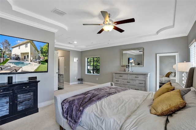 bedroom with light carpet, a raised ceiling, ceiling fan, and ornamental molding