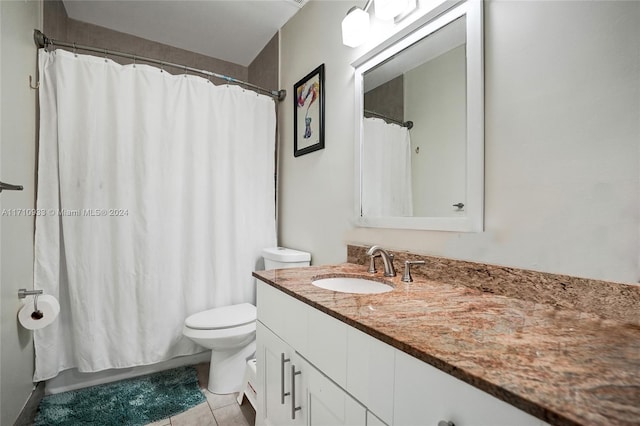 bathroom featuring toilet, vanity, tile patterned floors, and curtained shower