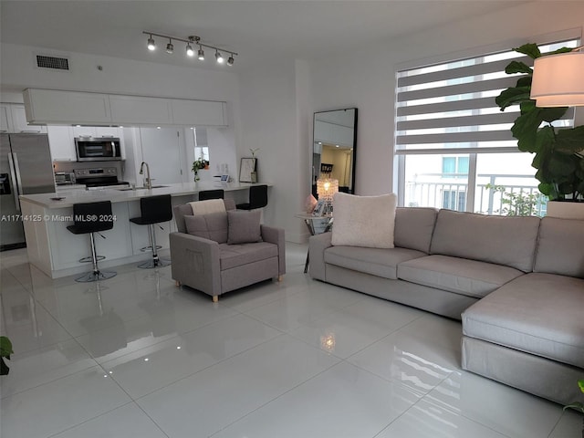 tiled living room featuring sink