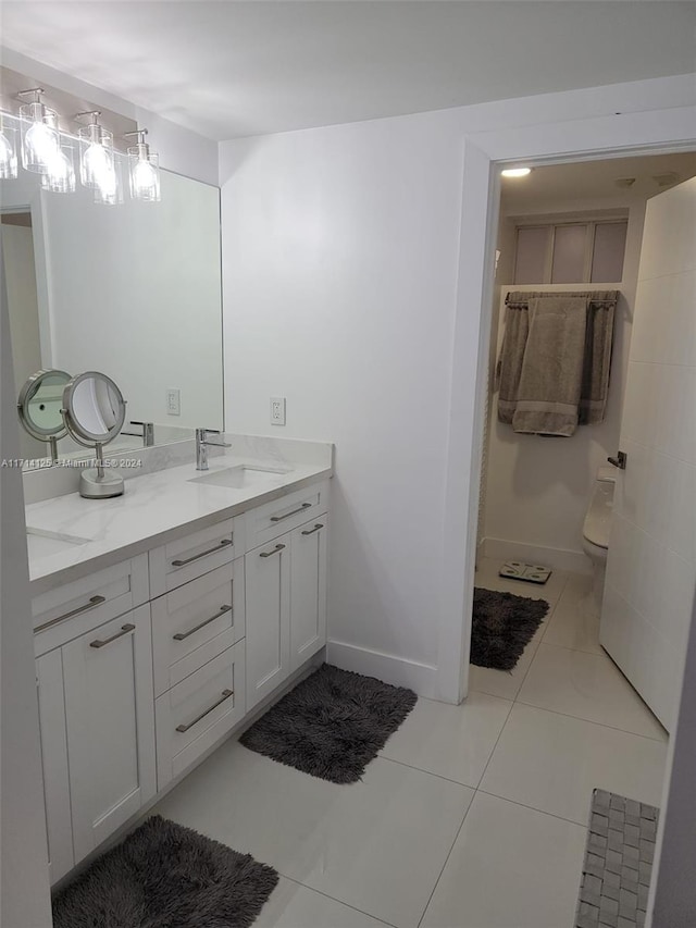 bathroom featuring tile patterned floors, vanity, and toilet