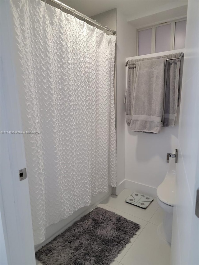 bathroom with tile patterned flooring and curtained shower