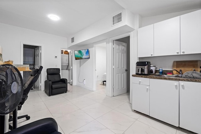 kitchen featuring white cabinetry and sink