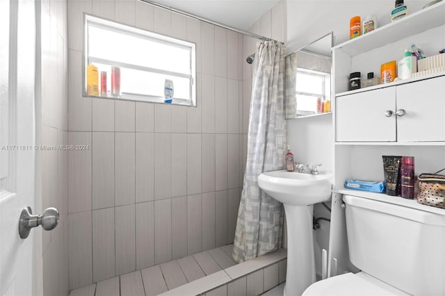 bathroom with toilet and walk in shower