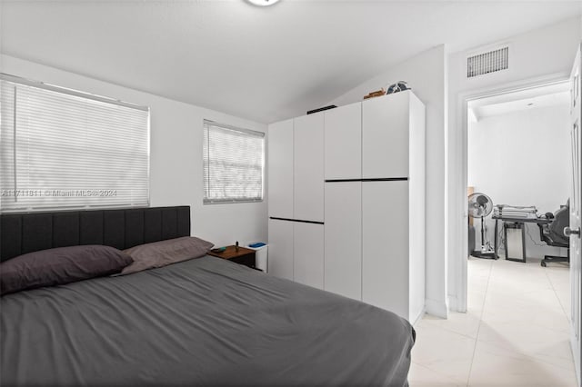 bedroom featuring vaulted ceiling