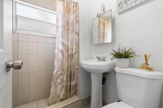 bathroom featuring a shower with shower curtain and toilet