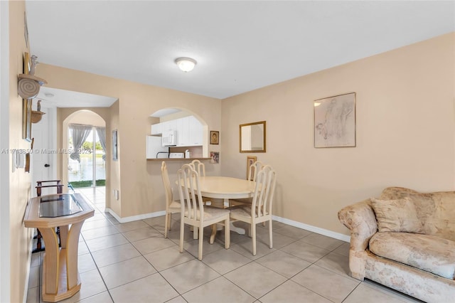 dining space featuring light tile patterned floors