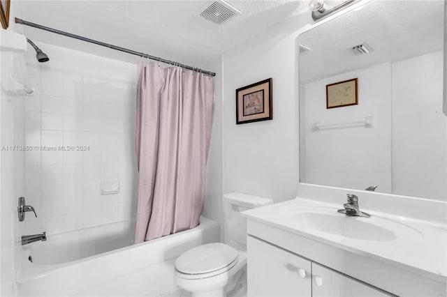 full bathroom featuring vanity, toilet, shower / bathtub combination with curtain, and a textured ceiling