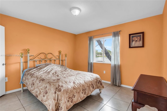 bedroom with light tile patterned floors