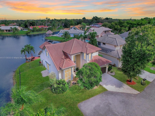 aerial view at dusk with a water view