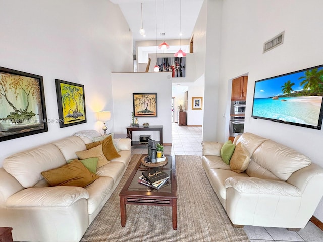 tiled living room featuring a high ceiling