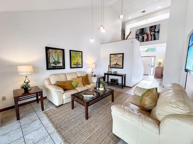 living room featuring light tile patterned floors and high vaulted ceiling