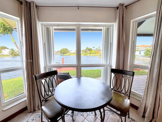 dining room with a water view and a healthy amount of sunlight