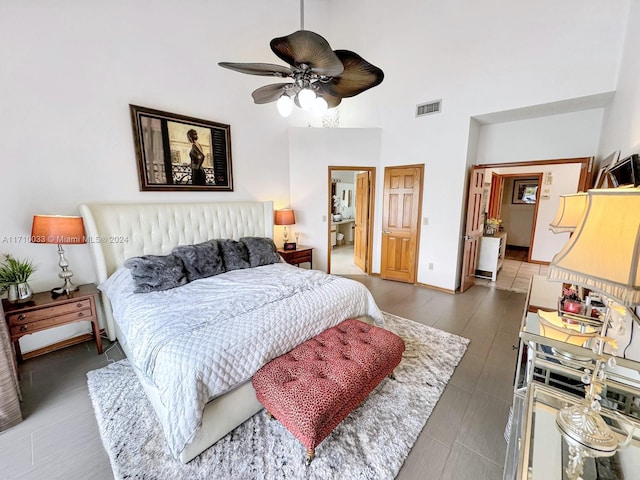 bedroom featuring ceiling fan and a high ceiling