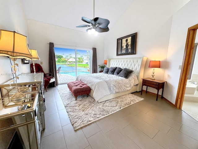 bedroom with high vaulted ceiling, ceiling fan, access to outside, and ensuite bath