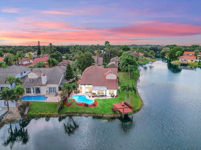 aerial view at dusk with a water view