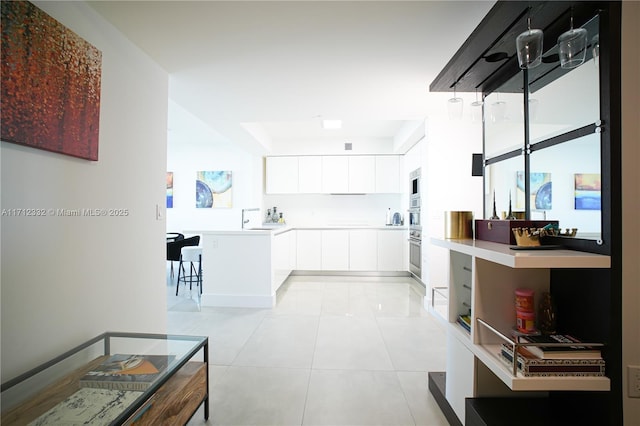 kitchen with white cabinets and light tile patterned floors