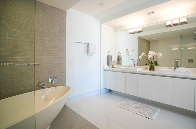 bathroom featuring tile patterned floors, vanity, and shower with separate bathtub