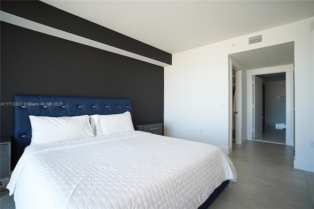 bedroom featuring concrete flooring