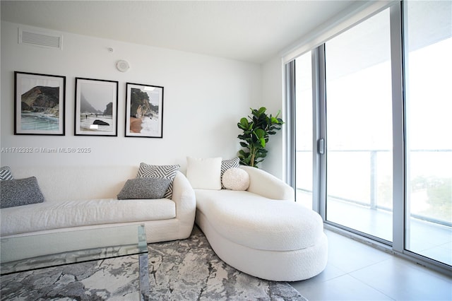 living room featuring floor to ceiling windows and tile patterned flooring