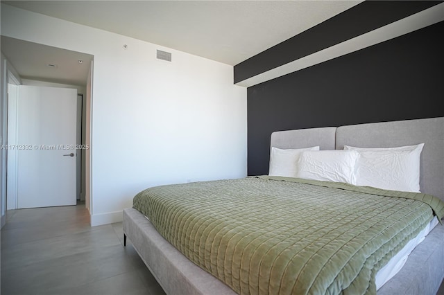 bedroom featuring concrete floors