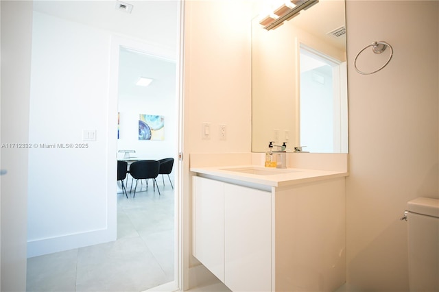 bathroom featuring tile patterned floors, vanity, and toilet