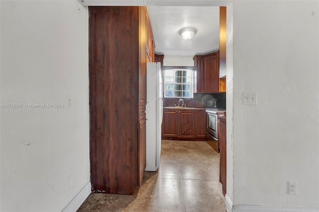 kitchen with decorative backsplash, sink, and white appliances