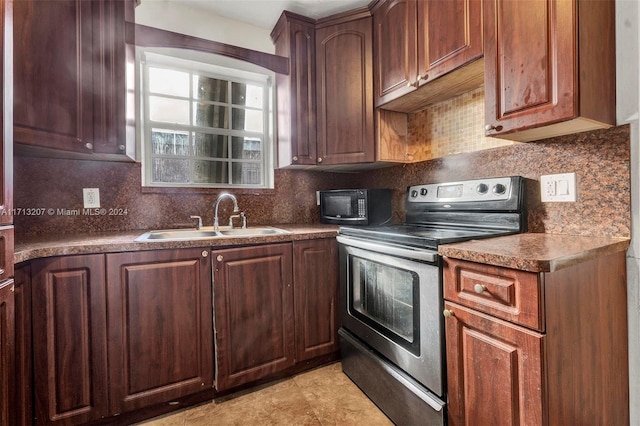 kitchen featuring decorative backsplash, stainless steel electric range oven, and sink