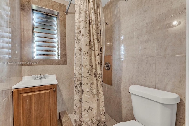 bathroom with toilet, vanity, tile walls, and walk in shower