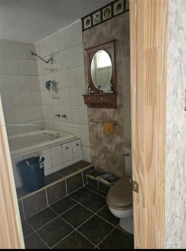 bathroom with tile patterned flooring, independent shower and bath, tile walls, and toilet