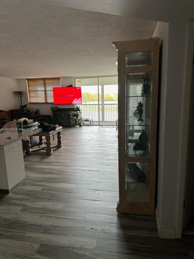 hall with hardwood / wood-style floors and a textured ceiling