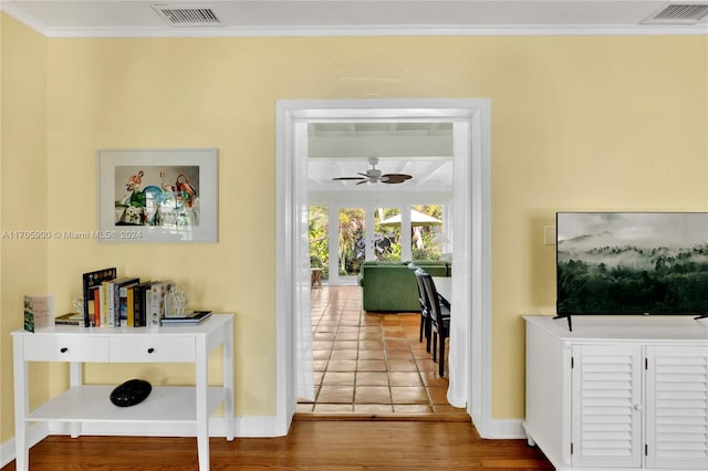 hall featuring hardwood / wood-style floors and ornamental molding