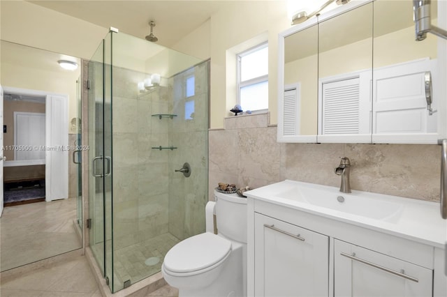 bathroom featuring vanity, a shower with shower door, tile walls, and toilet