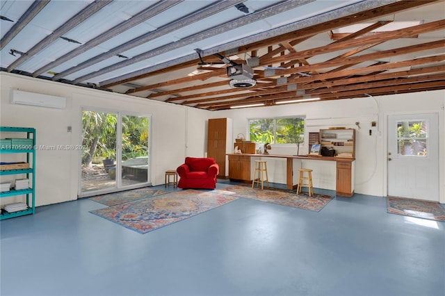 garage with a wall mounted air conditioner and a garage door opener