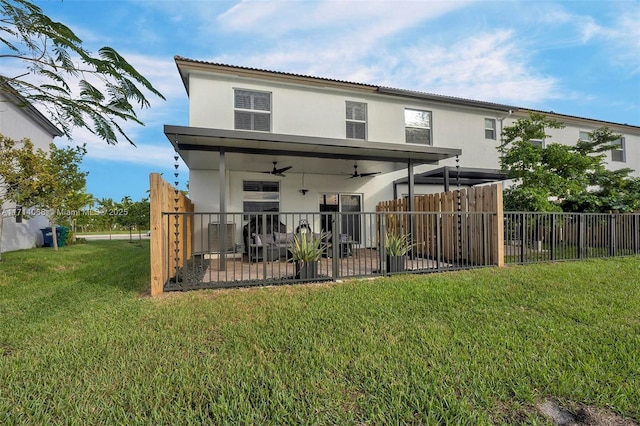 back of house with a yard and ceiling fan