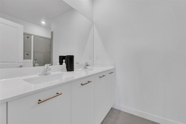 bathroom with tile patterned flooring, vanity, and a shower with door