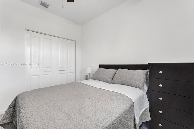 bedroom with ceiling fan and a closet